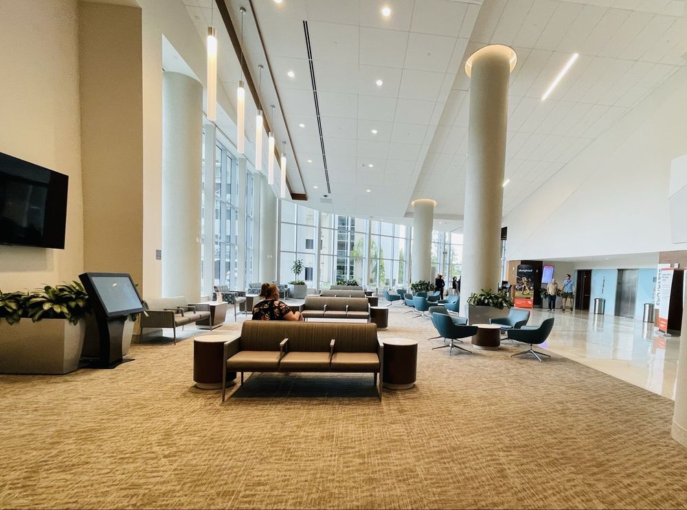Light-filled institute lobby with seating and Starbucks